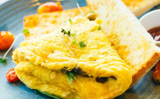 Spanich omelet with bread and tomato sauce for breakfast